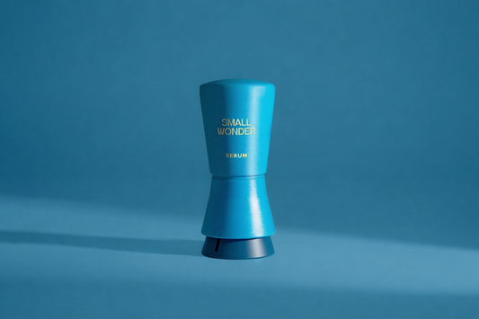 Blue cylindrical container labeled 'Small Wonder' on a blue background